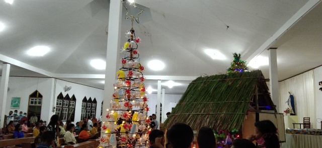 Pohon natal yang dihiasi bola mirip Corona, masker dan sarung tangan di Gereja St Monfort Pir Butong.