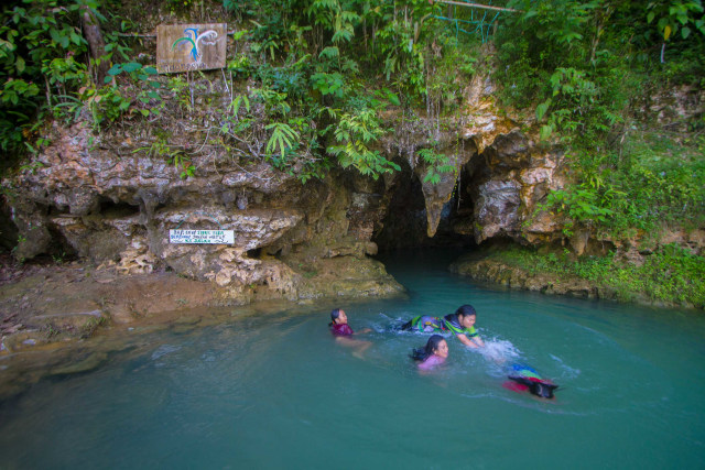 Wisatawan berenang di goa Liang Tapah di Desa Geragata, Kabupaten Tabalong, Kalimantan Selatan, Minggu (27/12/2020). Foto: BAYU PRATAMA S/ANTARA FOTO