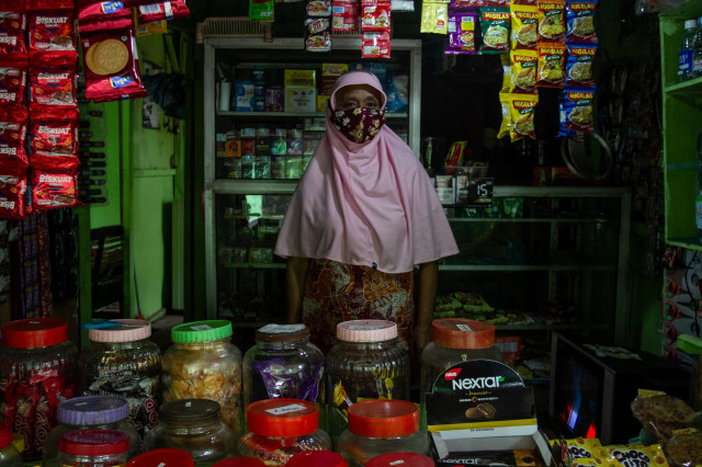 Nasabah Bank Wakaf Mikro Almuna Bekah Mandiri Endang Puruitanti berpose di depan usaha warung kelontong miliknya di Krapyak, Bantul, DI Yogyakarta. Foto: Hendra Nurdiyansyah/ANTARA FOTO