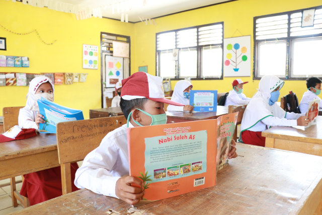 Siswa SDN 32/V Kampung Baru Batang Asam Tanjung Jabung Barat Jambi membaca buku di kelas. Foto: Ahmad Syaiful Bahri