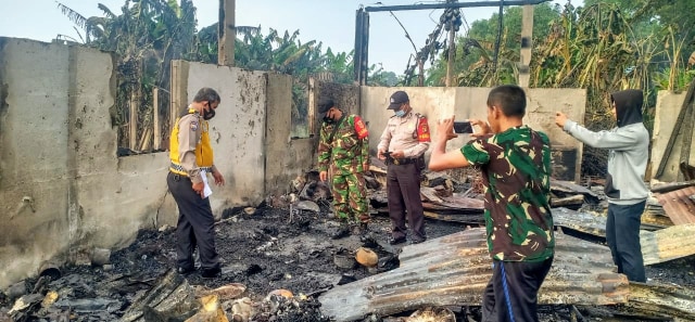 Petugas kepolisian melakukan olah TKP di lokasi kebakaran yang menyebabkan pasangan suami istri tewas di Palembang. (foto: istimewa)