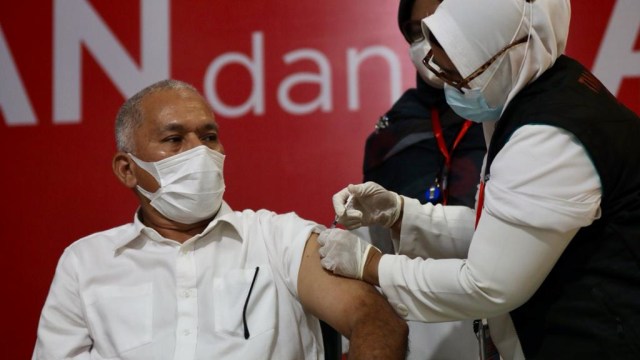 Sekda Aceh Taqwallah saat menjalani vaksinasi COVID-19 di RSUDZA Banda Aceh, Jumat (15/1/2021). Foto: Suparta/acehkini