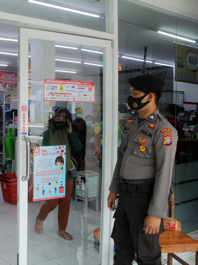 Polisi bersenjata lengkap  penjagaan di toko Mamuju, Sulawesi Barat, Rabu (20/1). Foto: Akbar /Antara Foto