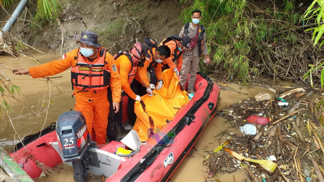 Petugas saat mengevakuasi mayat perempuan pada yang ditemukan mengapung di aliran sungai Bengawan Solo, turut wilayah Desa Kenongosari Kecamatan Soko Kabupaten Tuban. (foto: istimewa)