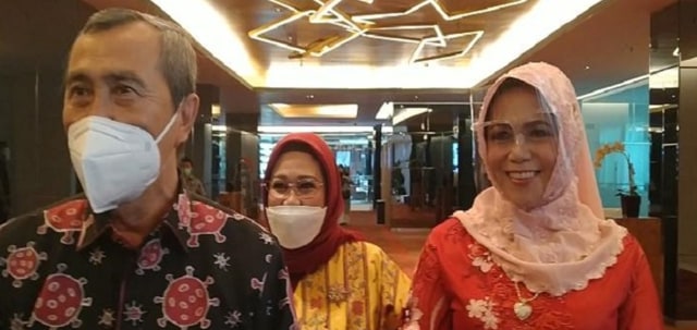 GUBERNUR Riau, Syamsuar, mengenakan baju batik motif Corona hasil jahitan istri tercinta, Misnarti (kanan), Jumat (19/2/2021).
