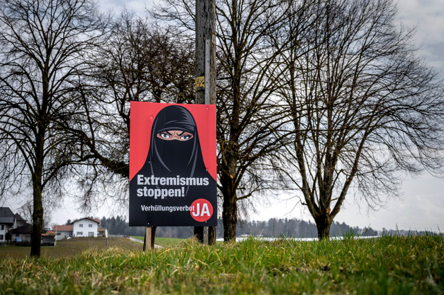 Poster pemilu yang mendukung larangan menggunakan cadar di Biberen. Foto: Fabrice Coffrini/AFP