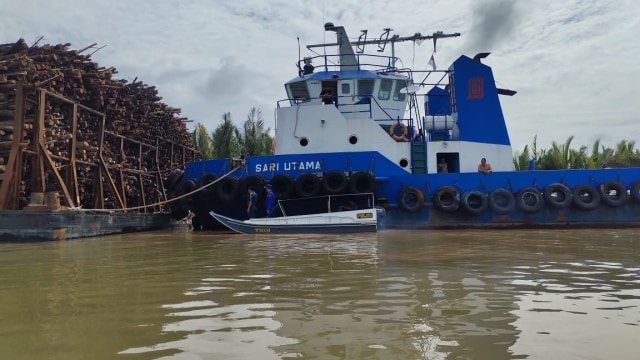 Kapal tongkang bermuatan kayu akasia saat diamankan di perairan Sungai Musi. Foto. Istimewa