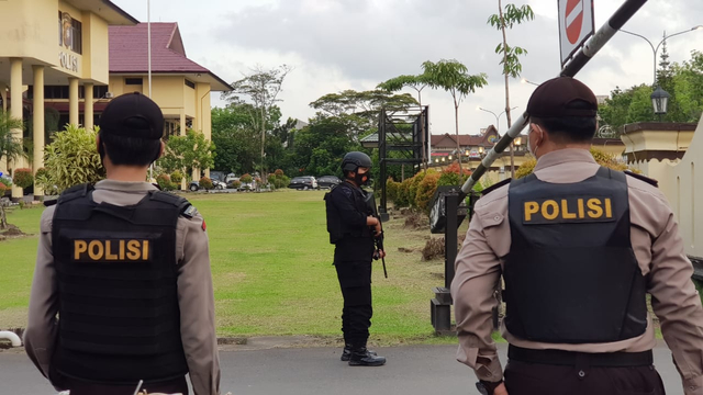 Personel Brimob mendampingi personel Yanma Polda Kalbar, berjaga di depan pintu masuk. Foto: Leo Prima/Hi!Pontianak