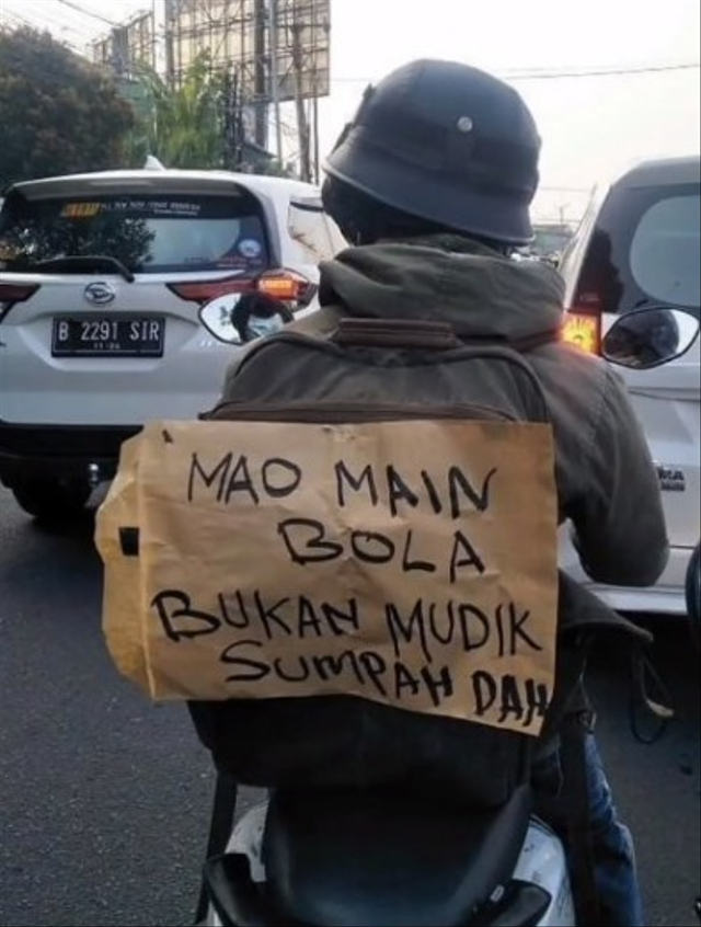 Momen kocak pengendara motor tempel kertas di tas ransel sebut dirinya bukan untuk mudik. (Foto: Instagram/@lambe_turah) 