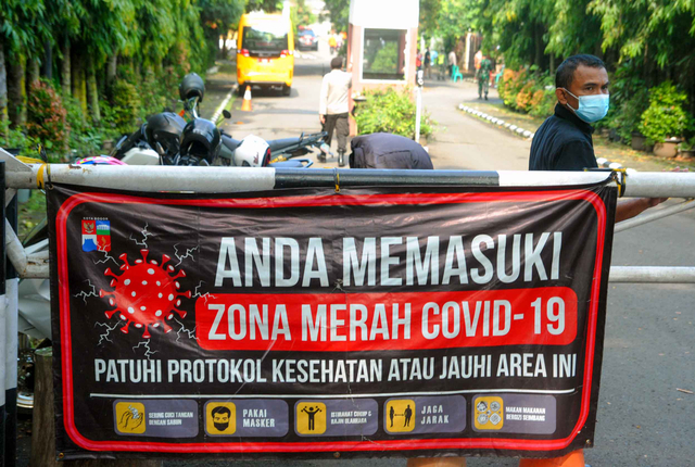 Petugas keamanan berjaga di depan gerbang masuk Perumahan Griya Melati, Kelurahan Bubulak, Kota Bogor, Jawa Barat, Kamis (20/5/2021). Foto: Arif Firmansyah/ANTARA FOTO
