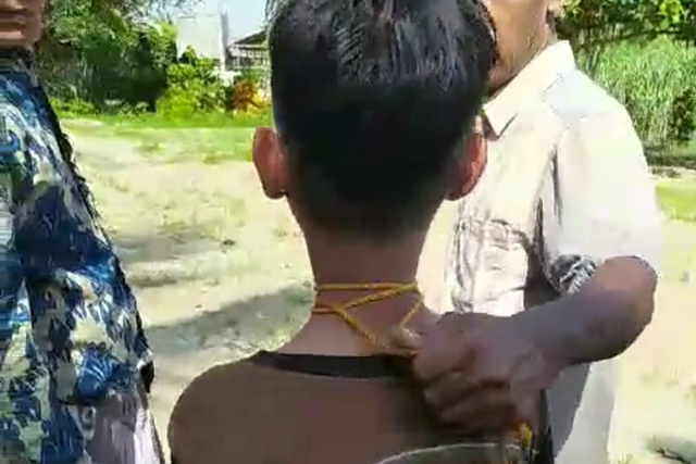 Tangkapan layar video tangan dan leher seorang anak di Aceh Utara dijerat dengan tali karena diduga mencuri celengan masjid yang beredar luas di media sosial.