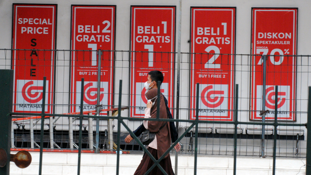 Warga berjalan melewati papan informasi potongan harga di gerai Matahari Department Store, Kapten Muslihat, Kota Bogor, Jawa Barat, Sabtu (29/5/2021). Foto: Arif Firmansyah/ANTARA FOTO