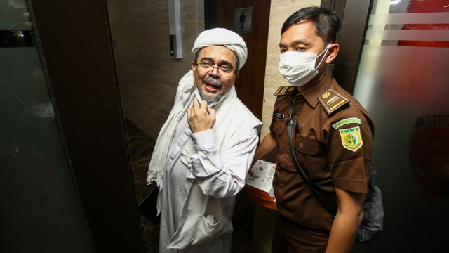 Terdakwa Habib Rizieq Shihab (kiri) memasuki gedung Bareskrim Polri usai menjalani sidang tuntutan di Jakarta, Kamis (3/6).  Foto: Rivan Awal Lingga/ANTARA FOTO
