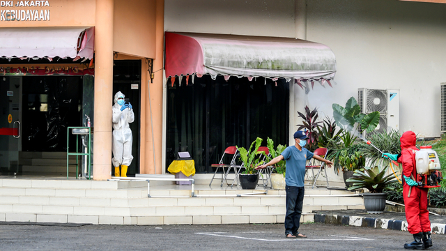 Petugas menyemprot cairan disinfektan pada pasien COVID-19 OTG saat tiba di Graha Wisata Ragunan, Kebagusan, Jakarta Selatan, Sabtu (12/6/2021). Foto: M Risyal Hidayat/ANTARA FOTO