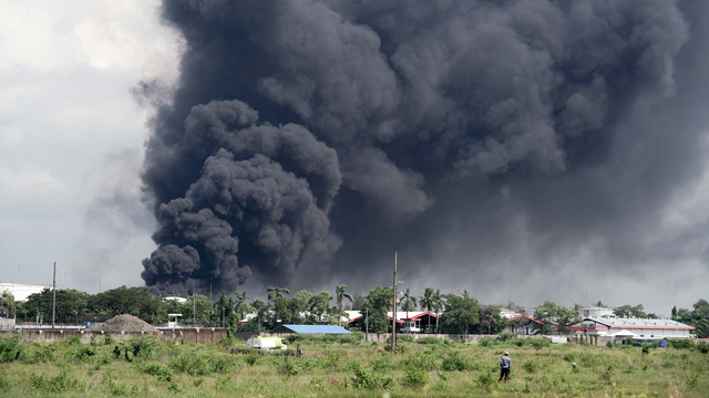 Asap hitam terlihat masih membumbung tinggi sesaat sebelum api berhasil dipadamkan, di Kilang Pertamina RU IV Cilacap, Jateng, Minggu (13/6/2021). Foto: Idhad Zakaria/ANTARA FOTO