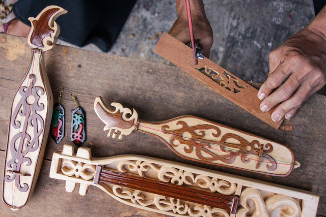 Perajin mengerjakan kerajinan miniatur tameng talawang Dayak dari limbah kayu di Galeri Tio Art, Palangkaraya, Kalimantan Tengah, Kamis (24/6/2021). Foto: ANTARA FOTO/Makna Zaezar