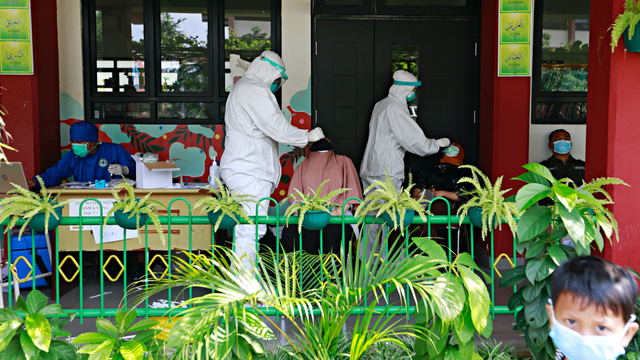 Sejumlah petugas kesehatan mengambil sampel swab di sebuah sekolah di Jakarta, Jumat (2/7). Foto: Ajeng Dinar Ulfiana/REUTERS