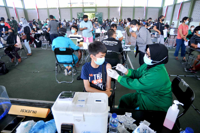 Vaksinator menyuntikkan vaksin COVID-19 kepada anak saat pelaksanaan program Serbuan Vaksinasi COVID-19 di Denpasar, Bali, Sabtu (3/7/2021). Foto: Fikri Yusuf/ANTARA FOTO