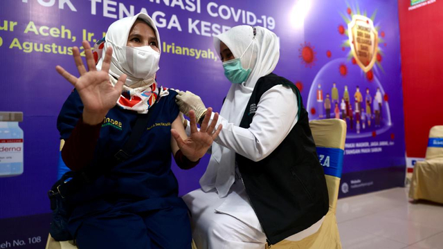 Tenaga kesehatan (nakes) RSUDZA Banda Aceh menerima suntikan vaksin corona dosis ketiga (booster) dengan vaksin Moderna, Senin (9/8/2021). Foto: Suparta/acehkini