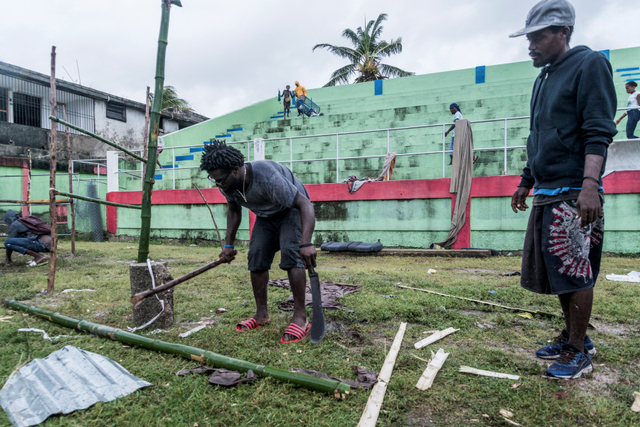 Pengungsi korban gempa di Haiti memperbaiki tenda pengungsian yang rusak akibat Badai Tropis Grace di Les Cayes, Haiti, Selasa (17/8). Foto: Reginald Louissaint Jr/AFP