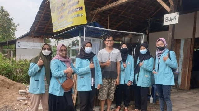 Mahasiswa KKN UNS Kelompok 289 berfoto bersama usai memasang parrtisi plastik di tempat berjuala salah satu warga Baturetno, Wonogiri.
