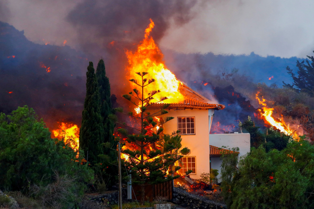 Sebuah rumah terbakar akibat lahar dari letusan gunung berapi di taman nasional Cumbre Vieja di Los Llanos de Aridane, di Pulau Canary La Palma, Spanyol. Foto: Borja Suarez/REUTERS