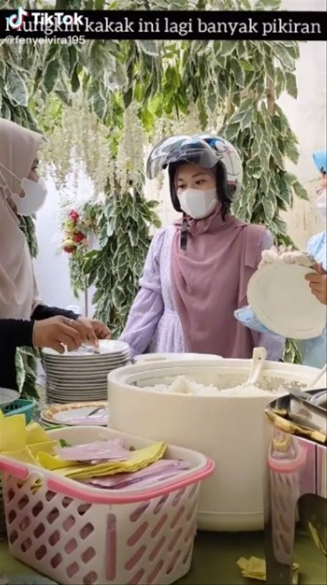 Momen kocak seorang wanita lupa buka helm saat berada di kondangan. (Foto: TikTok/@fenyelvira95)