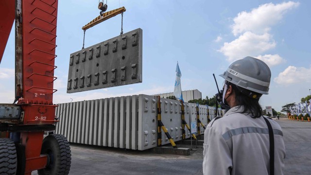 Pekerja menyusun bantalan rel (slab track) menggunakan alat berat gantry crane di Pabrik Slab Track PT WIKA Beton, Karawang, Jawa Barat, Rabu (18/5/2022). Foto: Asprilla Dwi Adha/Antara Foto