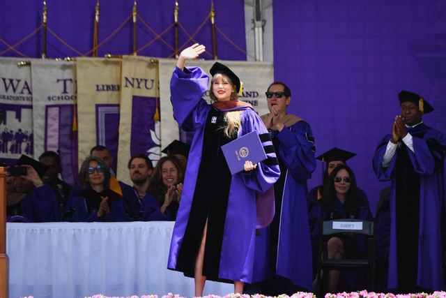 Penyanyi Taylor Swift melambaikan tangan saat upacara wisuda penerimaan gelar doktor kehormatan seni rupa dari Universitas New York di Yankee Stadium di New York, Amerika Serikat, Rabu (18/5/2022). Foto: Angela Weiss/AFP