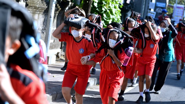 Sejumlah siswa berlari menuju bangunan tinggi saat latihan kesiapsiagaan bencana gempa dan tsunami di SD Negeri 2 Tanjung Benoa, Badung, Bali, Selasa (24/5/2022). Foto: Fikri Yusuf/ANTARA FOTO
