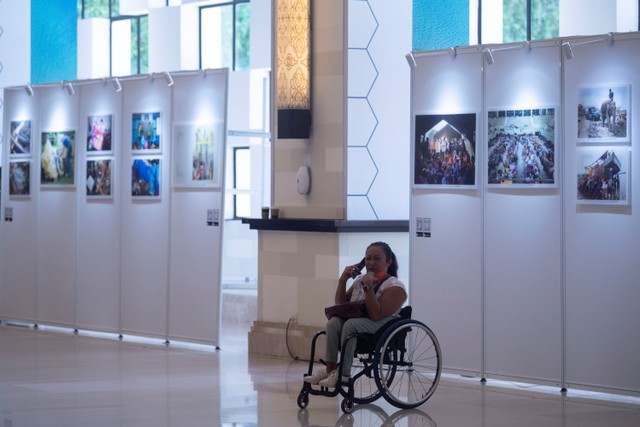 Delegasi berada di dekat karya foto yang ditampilkan dalam pameran foto bertajuk Indonesia Melalui Bencana saat penyelenggaraan Global Platform for Disaster Risk Reduction (GPDRR) 2022 di Nusa Dua, Bali, Rabu (25/5/2022). Foto: Aprillio Akbar/ANTARA FOTO