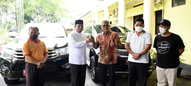 Mantan Wakil Bupati Kotawaringin Barat Ahmadi Riansyah secara simbolis menyerahkan kunci mobil dinas kepada Pemkab Kobar yang diwakili oleh Sekda Suyanto. Foto: Prokom