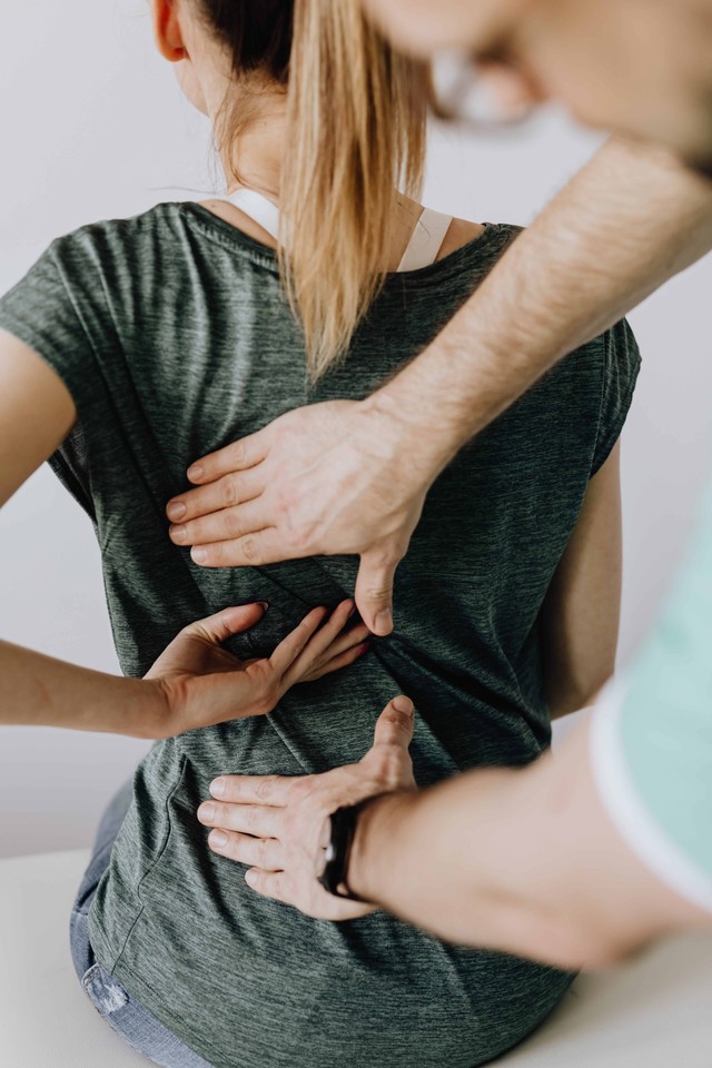 Photo by Karolina Grabowska from Pexels: https://www.pexels.com/photo/crop-orthopedist-examining-back-of-anonymous-patient-in-clinic-4506113/