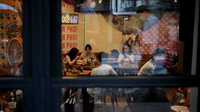 Pelanggan menikmati makan siang mereka di dalam restoran, di Shanghai, China, Rabu (29/6/2022). Foto: Aly Song/REUTERS