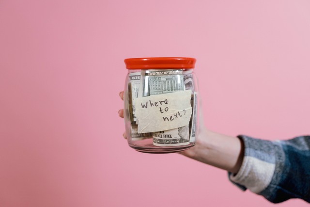 https://www.pexels.com/photo/a-person-holding-a-glass-jar-with-money-7009864/