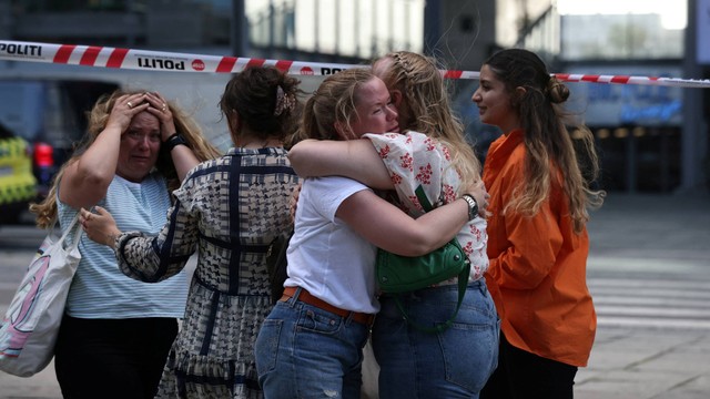 Orang-orang berpelukan di luar pusat perbelanjaan Fields, setelah insiden penembakan di lokasi tersebut, di Kopenhagen, Denmark, Minggu (3/7/2022). Foto: Ritzau Scanpix/Olafur Steinar Gestsson via REUTERS