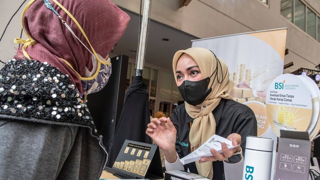 Petugas berbincang dengan warga yang akan menabung emas di gerai Gadai Emas dan Cicil Emas BSI di Pasar Mayestik, Kebayoran Baru, Jakarta, Rabu (6/7/2022). Foto: Muhammad Adimaja/ANTARA FOTO