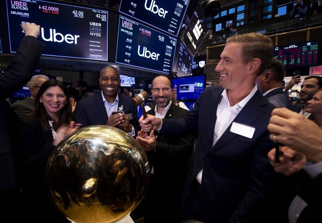 CEO pertama Uber, Ryan Graves (kanan), membunyikan bel di New York Stock Exchange (NYSE), New York, Amerika Serikat pada Jumat (10/5/2019). Foto: Johannes Eisele/AFP