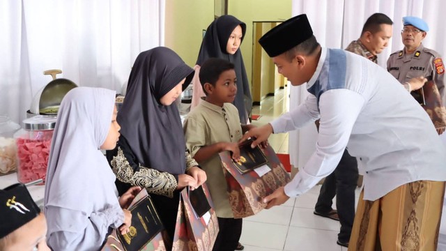 Kepala Kepolisian Resor (Kapolres) Aceh Barat AKBP Pandji Santoso menyerahkan santunan kepada anak yatim piatu pada halal bihalal, Minggu (10/7/2022). Foto: Dok. Polres Aceh Barat