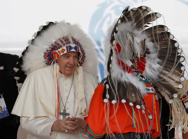 Paus Fransiskus menerima hiasan kepala dari penduduk asli selama kunjungannya ke Maskwacis, Alberta, Kanada 25 Juli 2022.
 Foto: REUTERS/Todd Korol 