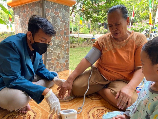 Mohammad Rendo Ariyansyah sedang melakukan pemeriksaan tekanan darah pada warga Kelurahan Kalisegoro. (Sumber: Dokumentasi Pribadi)