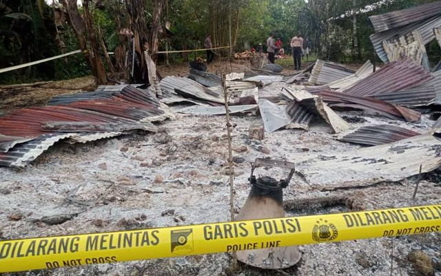 Garis polisi yang membatasi rumah milik Yali Magayang di Yahukimo yang rumahnya dibakar oleh 6 orang.  (Foto Humas Polda Papua)  