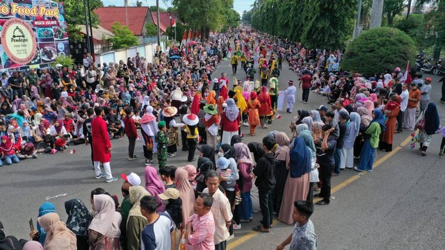 Warga menyaksikan pawai di Banda Aceh. Foto: Abdul Hadi/acehkini 