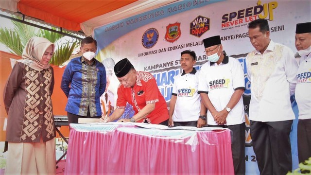 Kepala BNN Kabupaten Gorontalo, Roy Bau saat menandatangani PKS dengan tiga desa. Kamis, (18/8). Foto: Dok Burdu/banthayo