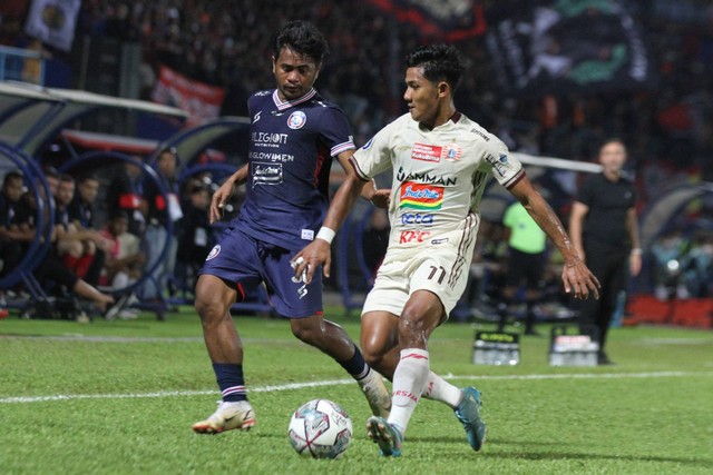 Pesepak bola Arema FC, Ilham Udin (kiri) berusaha menghalangi laju pesepak bola Persija Jakarta, Firza Andika (kanan) dalam pertandingan BRI Liga 1 di Stadion Kanjuruhan, Malang, Jawa Timur, Minggu (28/8/2022). Foto: Ari Bowo Sucipto/ANTARA FOTO