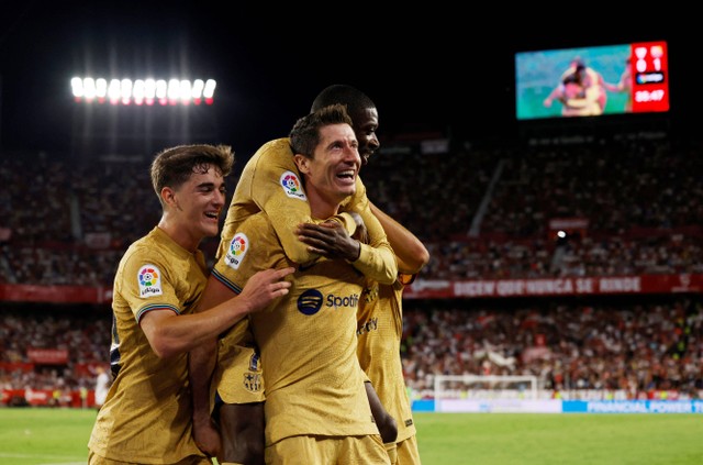 Pemain FC Barcelona Robert Lewandowski merayakan gol keduanya bersama rekan setim saat pertandingan melawan Sevilla di Ramon Sanchez Pizjuan, Seville, Spanyol, Sabtu (3/9/2022). Foto: Marcelo Del Pozo/Reuters