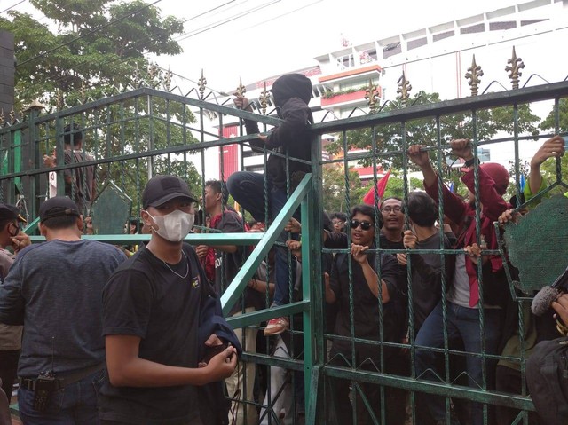 Demonstran naiki pagar dan melampari botol di DPRD Jawa Tengah, Semarang, Kamis (8/9/2022). Foto: Intan Alliva/kumparan
