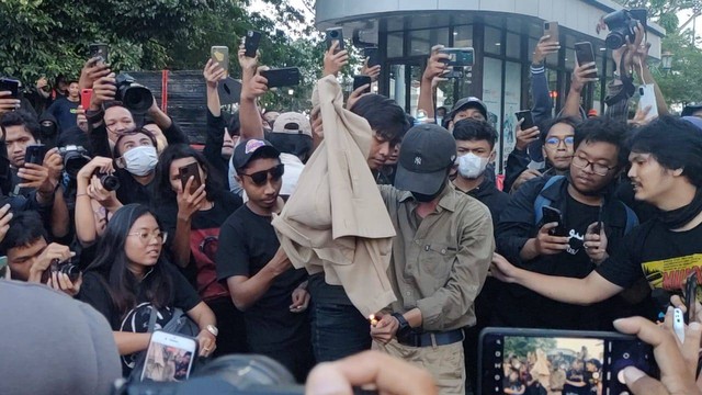 Mahasiswa Universitas Gadjah Mada (UGM) membakar alamamater dalam aksi demo tolak kenaikan BBM di depan Gedung Agung atau Istana Negara Yogyakarta, Kamis (15/9/2022). Foto: Arfiansyah Panji/kumparan