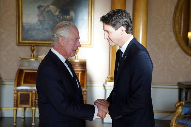 Raja Charles III berjabat tangan dengan Perdana Menteri Kanada, Justin Trudeau, di Ruang 1844 di Istana Buckingham di London, Inggris, Sabtu (17/9/2022). Foto: Stefan Rousseau/Pool via REUTERS