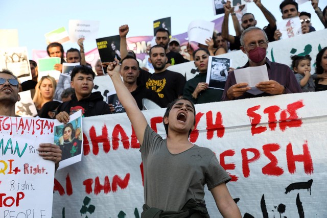 Orang-orang menggelar protes setelah kematian Mahsa Amini di Iran, di Athena, Yunani, Sabtu (24/9/2022).
 Foto: Louiza Vradi/REUTERS